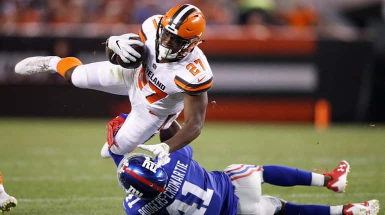 Giants cornerback Dominique Rodgers-Cromartie tackles Browns running back Matthew Dayes...