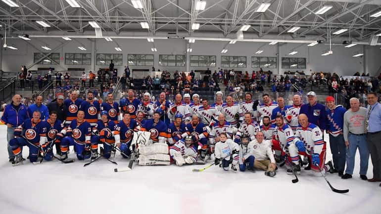 Alumni of the Islanders and Rangers pose for a photo...