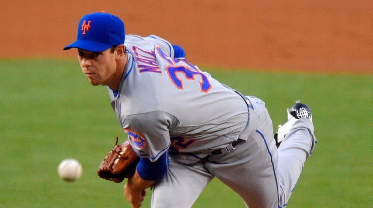 New York Mets starting pitcher Steven Matz throws to the...