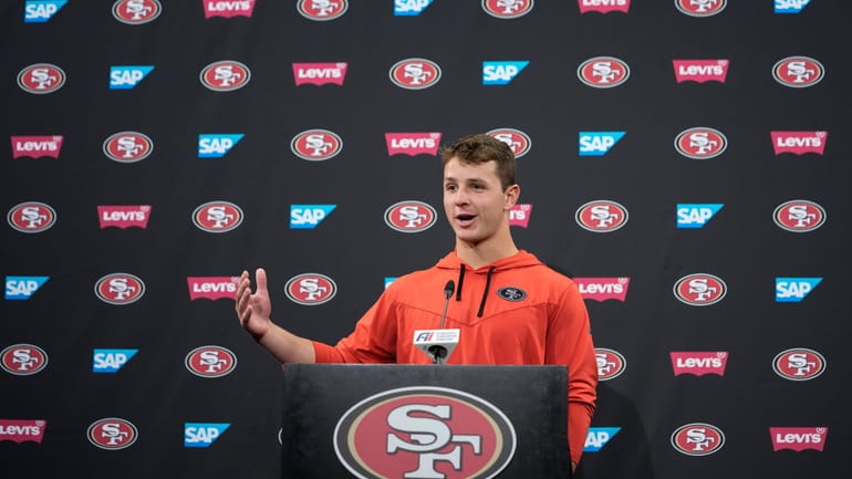 San Francisco 49ers quarterback Brock Purdy speaks to reporters after...