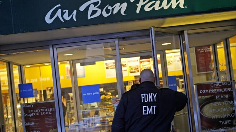 A patron wearing an FDNY EMT jacket enters the Au...