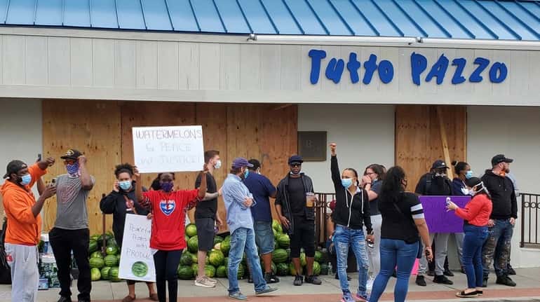 Demonstrators gather outside Tutto Pazzo in Huntington on Tuesday, June 2,...