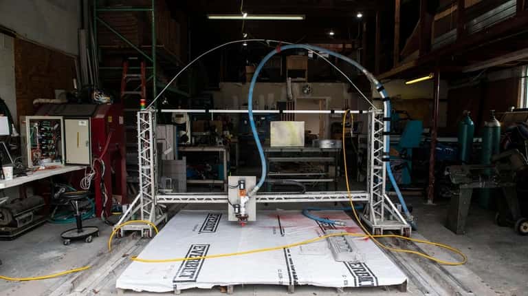 A small version of S-Squared's 3D printer is warehoused in Patchogue.