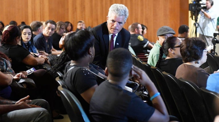 Suffolk County Executive Steve Bellone speaks with people before a...