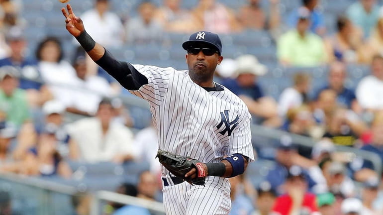 Yankees shortstop Eduardo Nunez throws to first base against the...