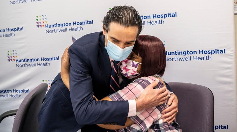 Alisa White, of Wyandanch, hugs Dr. Demetrios Tzimas at Huntington Hospital on Tuesday.