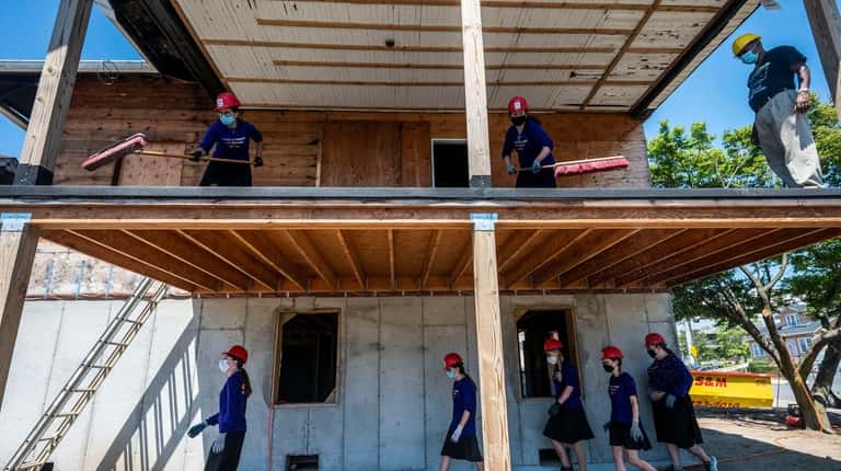 Orthodox Jewish teen girls help rebuild the home of James Hodge,...