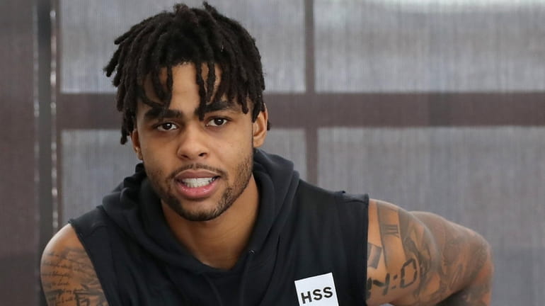 Nets guard D'Angelo Russell takes a break during training camp...