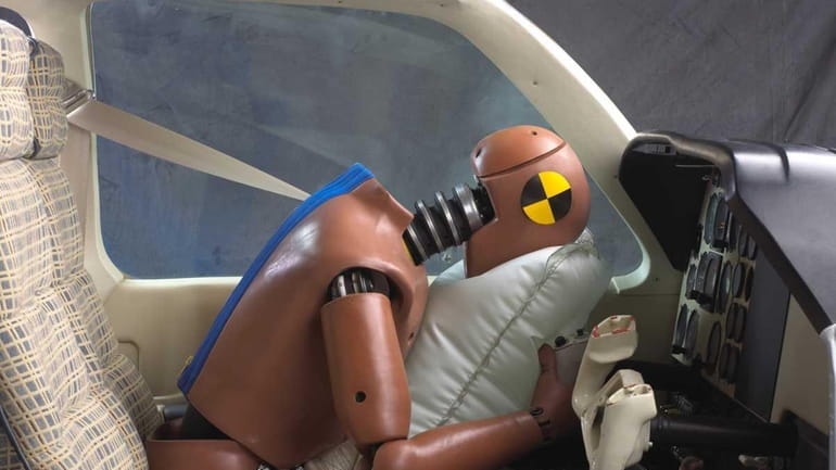 A crash dummy demonstrates an aviation air bag use in...