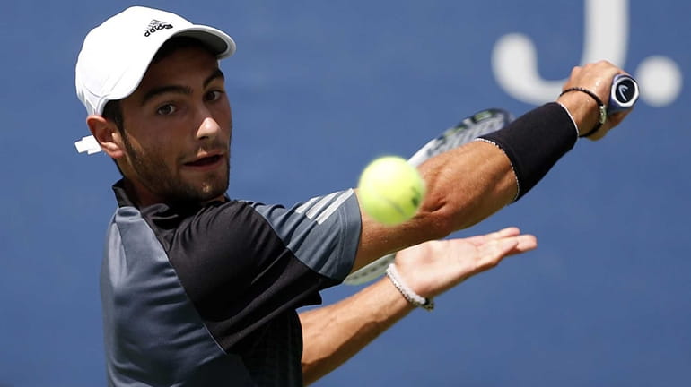 Noah Rubin lines up a backhand in a match against...