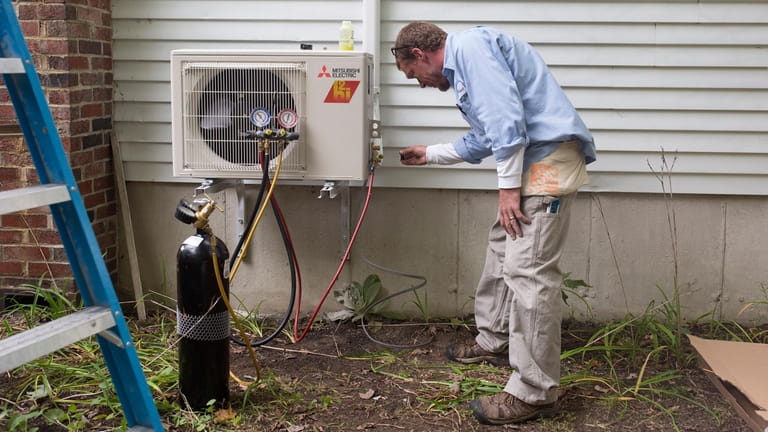 A technician installs a heat pump in Maine in the...