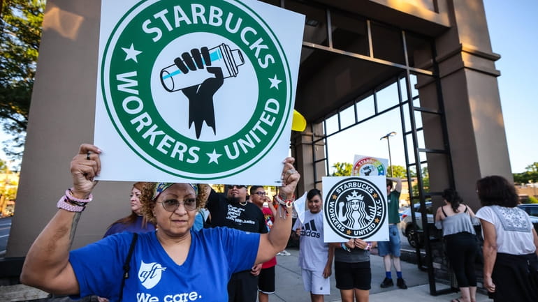 Pro-union protestors rally outside a Starbucks in Great Neck demanding...