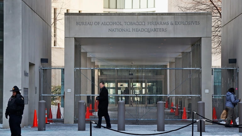 A security official walks in front of the entrance to...
