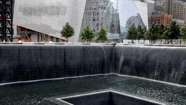 The waterfall of the North Tower reflecting pool flows at...