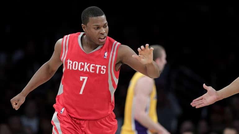 Houston Rockets' Kyle Lowry slaps hands with a teammate after...