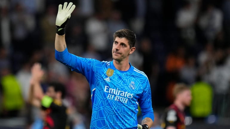 Real Madrid goalkeeper Thibaut Courtois waves to fans at the...