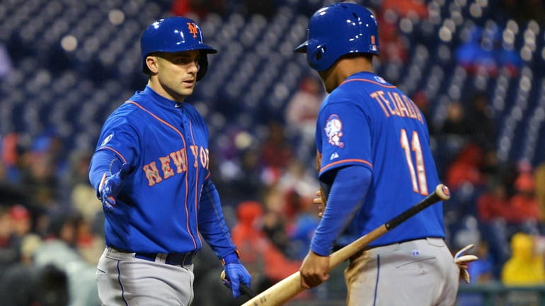 Ruben Tejada of the Mets is congratulated by David Wright...