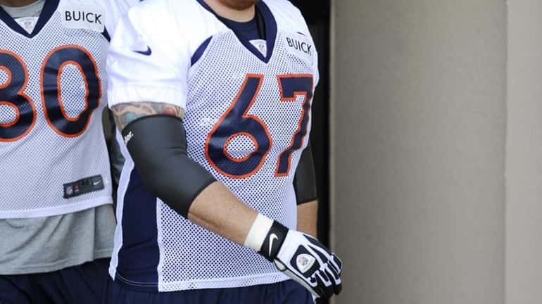 Denver Broncos center Dan Koppen walks out of the locker...