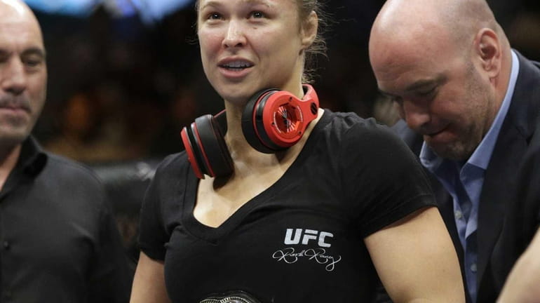 Ronda Rousey looks up after defeating Alexis Davis in their...