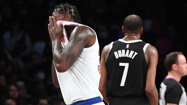 Knicks forward Julius Randle walks down court past Nets forward Kevin...