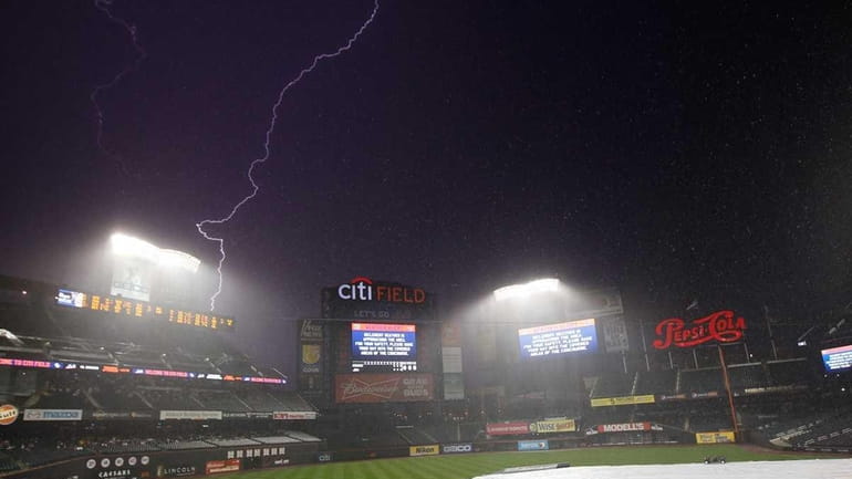 Lightning strikes in the distance during a weather delay before...