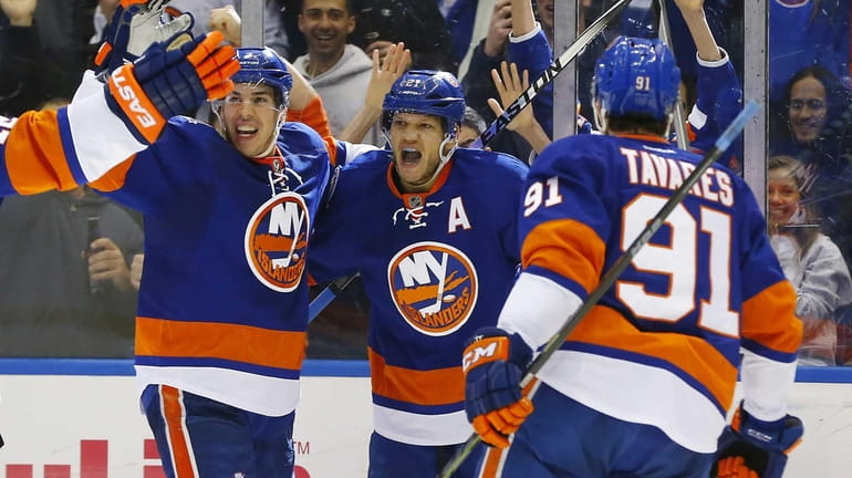 Kyle Okposo of the New York Islanders celebrates his third...