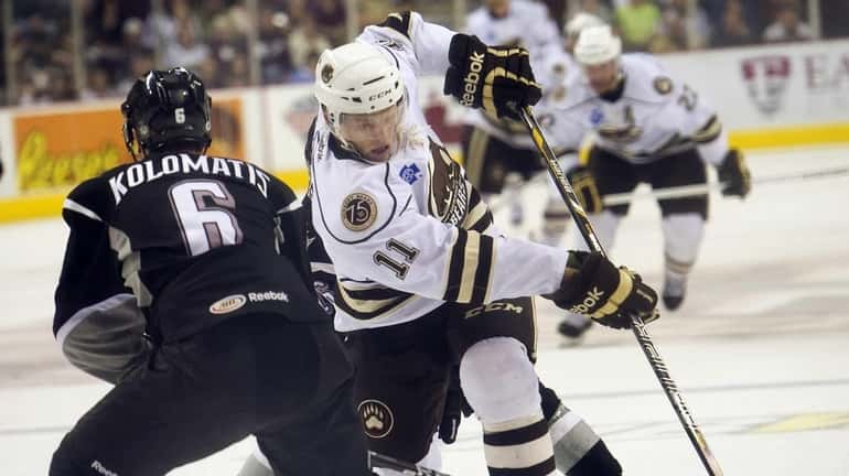 The Hershey Bears' Joey Crabb (11) charges toward the goal...