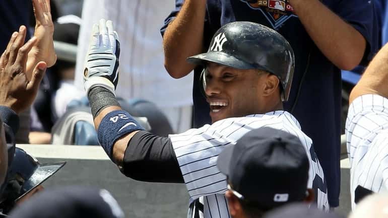 The Yankees' Robinson Cano celebrates his fourth-inning home run against...