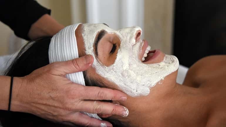 Erica Chan gets a facial from aesthetician Amber Lally at her...
