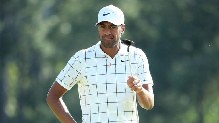 Tony Finau reacts on the 18th green during the third...