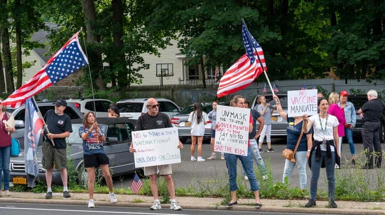 Protesters gather outside the Stony Brook LIRR station.
