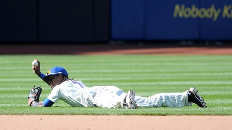 Mets shortstop Jose Reyes shows the baseball to the umpire...