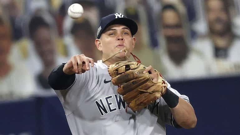 Yankees third baseman Gio Urshela throws Rays batter Yandy Diaz...