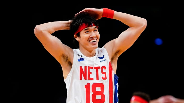 Nets' Yuta Watanabe (18) celebrates with teammates after a dunk...