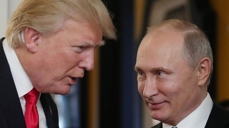 President Donald Trump speaks with Russian President Vladimir Putin at...