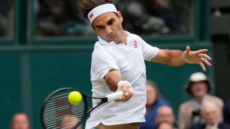 FILE - Switzerland's Roger Federer returns the ball to Italy's...