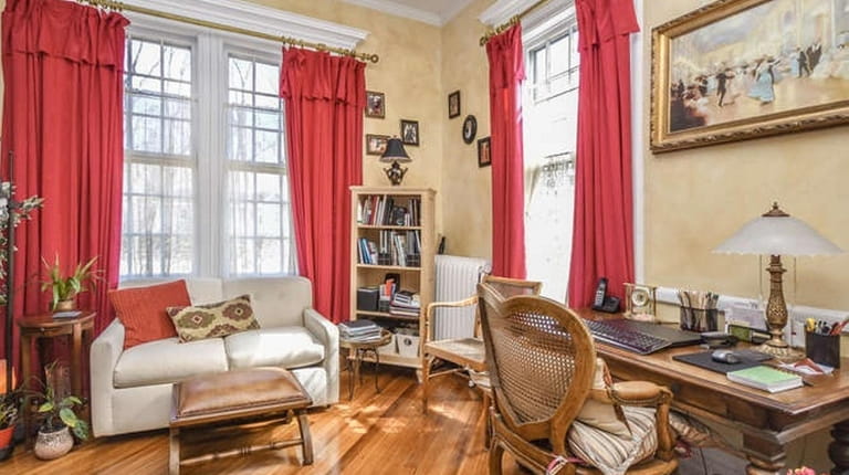 The three-bedroom house has high ceilings and original decorative woodwork...