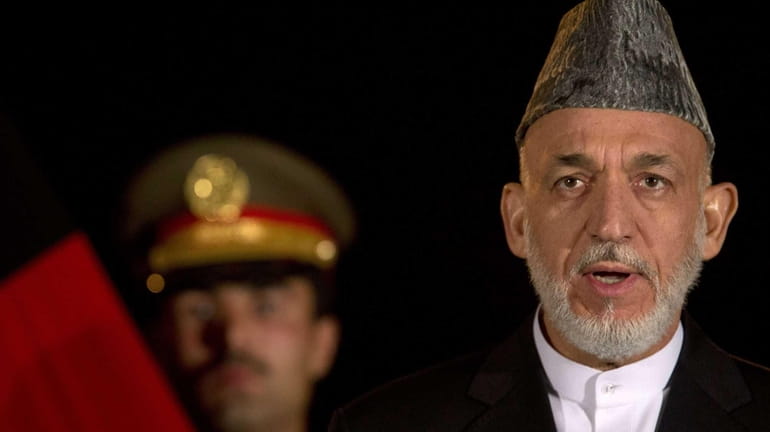 Afghan President Hamid Karzai speaks during a news conference with...