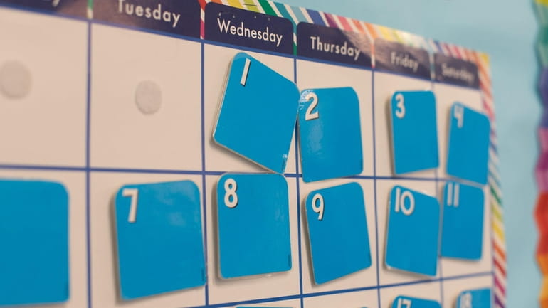 A calendar in a classroom.