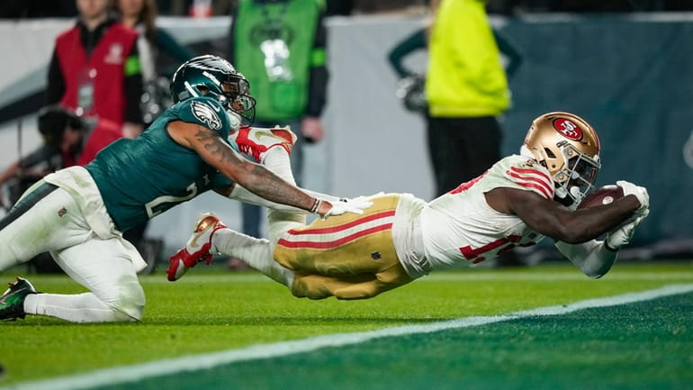 49ers wide receiver Deebo Samuel, right, dives in for a...