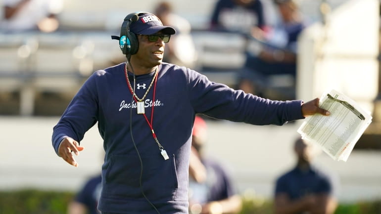 Jackson State football coach Deion Sanders calls out a play...