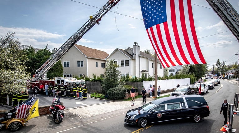 The hearse with Sgt. Robert Hendriks arrives at Whitting Funeral...