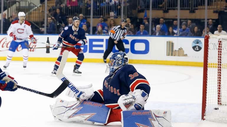 Henrik Lundqvist, #30, of the New York Rangers surrenders a...