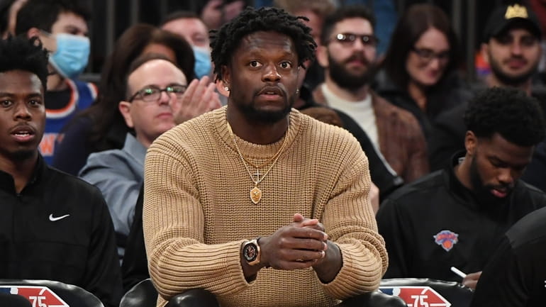 Knicks forward Julius Randle looks on from the bench in...