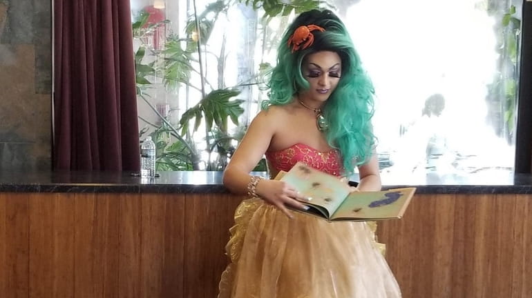 Bella Noche reads to children during her first drag queen story...