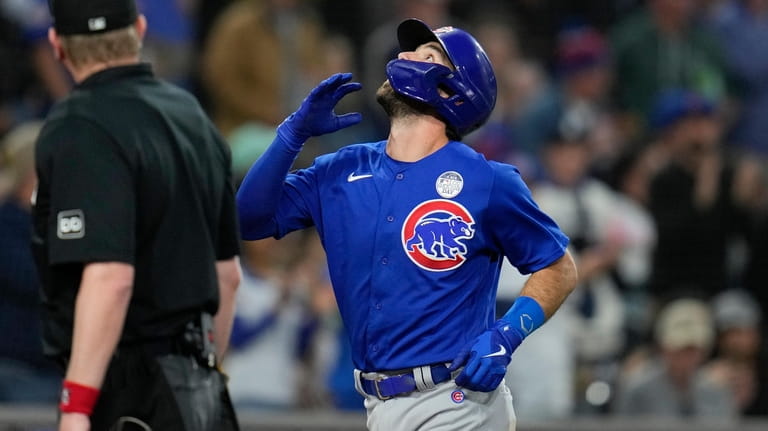 Chicago Cubs' Dansby Swanson celebrates after hitting a home run...