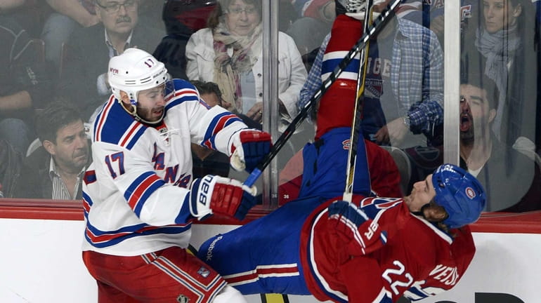 Rangers' John Moore, left, takes Montreal Canadiens' Dale Weise into...