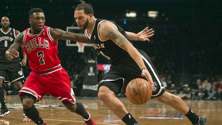 Nets' Deron Williams drives the baseline against the Chicago Bulls'...