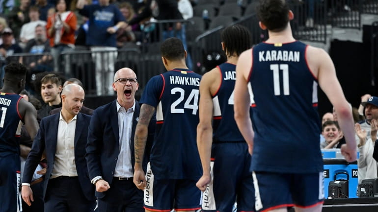 UConn head coach Dan Hurley, middle, celebrates towards his players...