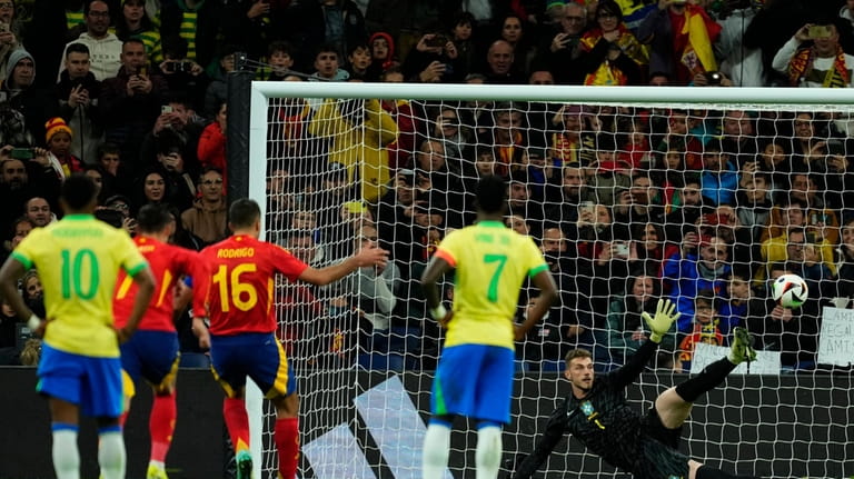 Spain's Rodrigo, 3rd left, scores the opening goal with a...